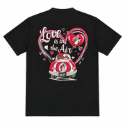 Buc-ee's Love is in the Air Valentine's T-shirt back print: beaver in a red vintage car under a pink heart on black
