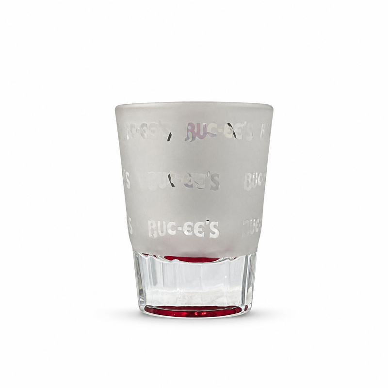 Back of the Buc-ee's Melissa, TX shot glass showing frosted glass with a repeating clear Buc-ee's wordmark pattern