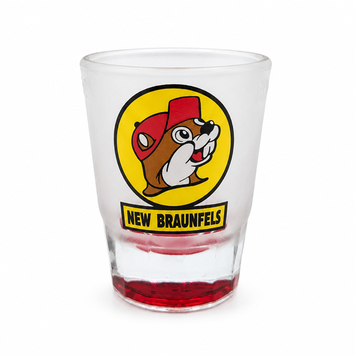 Buc-ee's New Braunfels shot glass in frosted clear glass with the yellow beaver mascot logo and a red-tinted base