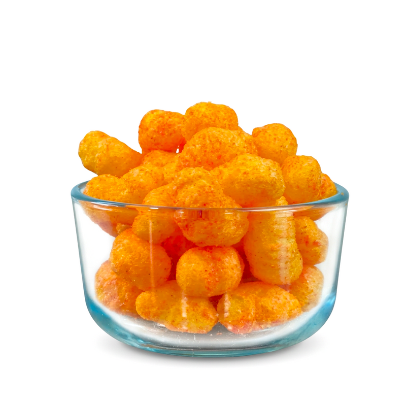 Buc-ee’s Nug-ees Bold ‘n Sorta Spicy baked corn puffs in a clear glass bowl, showing their spice-dusted texture up close