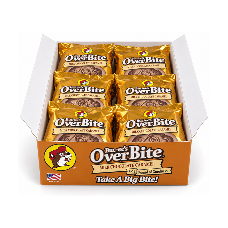 Open Buc-ee's OverBite Milk Chocolate Caramel 12-count box shown straight on against a white background, with the orange front panel and six individually wrapped cookies in shiny gold foil wrappers visible inside.