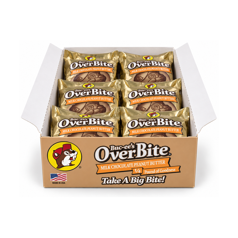 Open Buc-ee's OverBite Milk Chocolate Peanut Butter 12-count box shown straight on against a white background, with the tan front panel and six individually wrapped cookies in pale gold foil wrappers visible inside.
