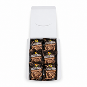 Top-down view of an open Buc-ee's OverBite Milk Chocolate - Chocolate Truffle box on a white background, showing the top layer of six individually wrapped cookies in glossy dark brown wrappers.
