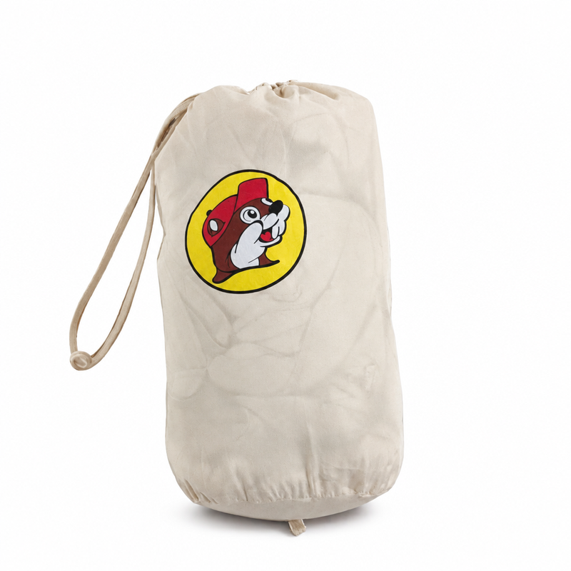 Buc-ee's Puffy Packable Winter Coat packed into its cream drawstring storage bag with yellow beaver logo