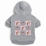 Back view of a heather gray pet hoodie laid flat, showing a printed graphic grid of alternating pink bows and Buc-ee's beaver logos.
