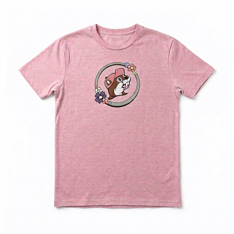 Buc-ee’s heather pink T-shirt with the beaver logo in a gray ring trimmed with pastel flowers on the chest