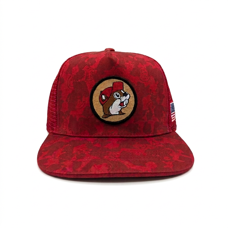 Front view of the Buc-ee’s red camo trucker hat, showing the embroidered beaver patch head-on above a flat brim