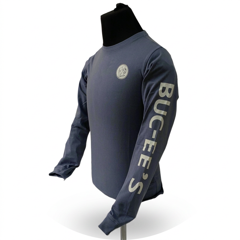 Side view of Buc-ee’s slate blue long-sleeve shirt on a mannequin, showing the full sleeve lettering and chest logo