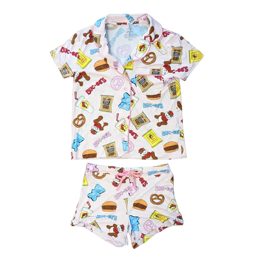 Buc-ee’s Snacks Pajama Set with a light pink button-up short sleeve top with pink piping and matching shorts in a snack print