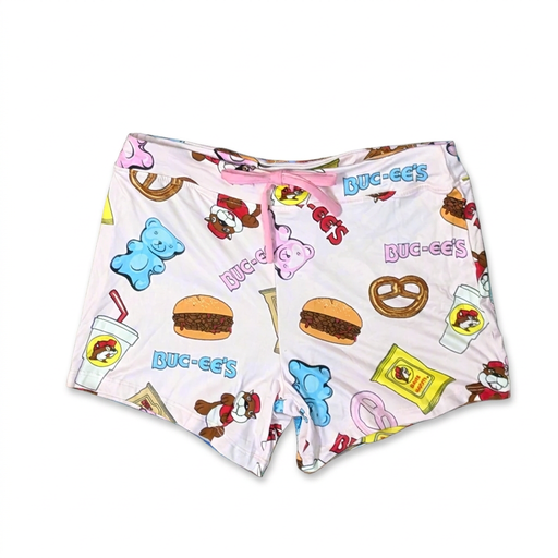 Buc-ee’s Snacks Pajama Shorts in light pink with a pink drawstring and a print of brisket sandwiches, pretzels, and gummy bears