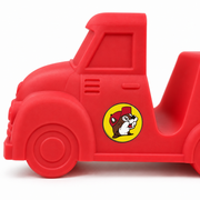 Close-up of a red silicone Buc-ee's Taco Truck taco holder showing the cab, embossed wheel and round Buc-ee's beaver sticker on the door.
