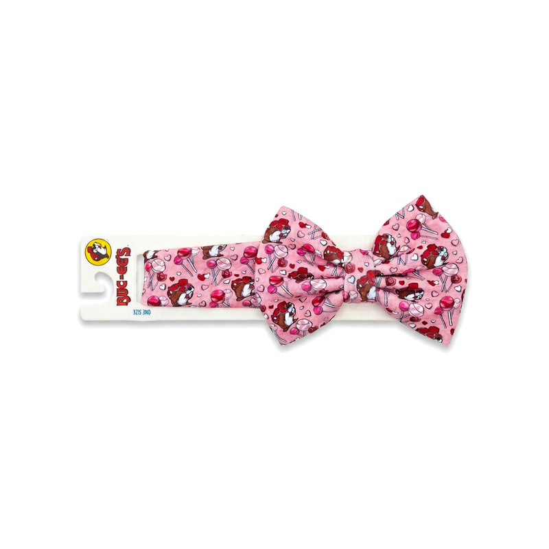 Buc-ee's pink Valentine's headband with a large bow, Buc-ee the Beaver, lollipop and heart print, on a hang card