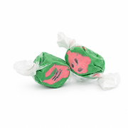 Buc-ee's Watermelon Saltwater Taffy from a 12 oz bag, two pieces in twisted white wax paper with green and pink watermelon flavored candy