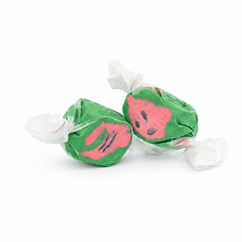 Buc-ee's Watermelon Saltwater Taffy from a 12 oz bag, two pieces in twisted white wax paper with green and pink watermelon flavored candy