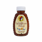 12 oz bottle of Buc-ee's raw and unfiltered Wildflower Honey on white
