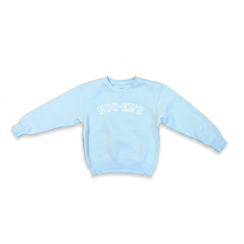 Buc-ee’s youth girls’ crewneck sweater in pale blue with white arched lettering and ribbed cuffs, front view