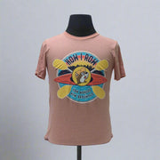 A pink-colored t-shirt featuring an graphic of Buc-ee's logo with text and a kayak motif.