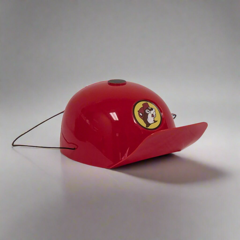 A single red reusable plastic party hat featuring the Buc-ee's logo, shown with a strap on a white background