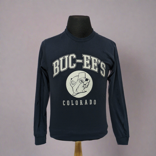 This is a long-sleeved Buc-ee's t-shirt in dark blue. It has bold white text that read "BUC-EE'S" followed by a white Buc-ee's logo, and then in smaller lettering, still in bold the word "COLORADO"