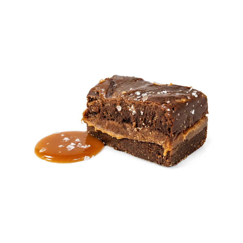 Buc-ee's Dark Chocolate Caramel Fudge, a layered square topped with sea salt flakes beside a pool of caramel sauce 