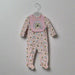 The pink rainbow sleeper with matching bib on a hanger