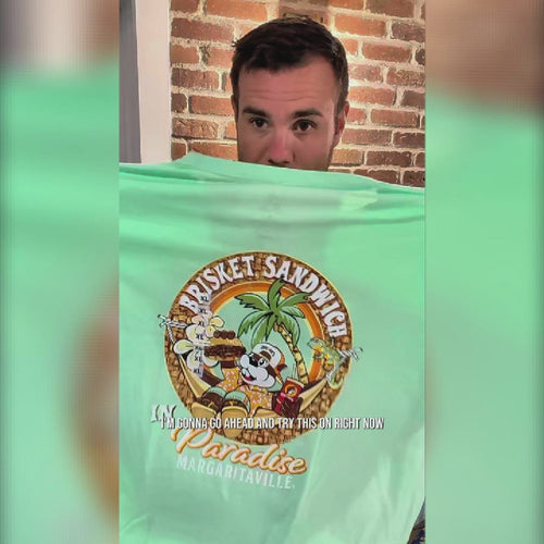Buc-ee’s lime green Margaritaville shirt review featuring a chest palm tree logo, a large “Brisket Sandwich in Paradise” back print, and unisex adult sizing from Small to 3X.
