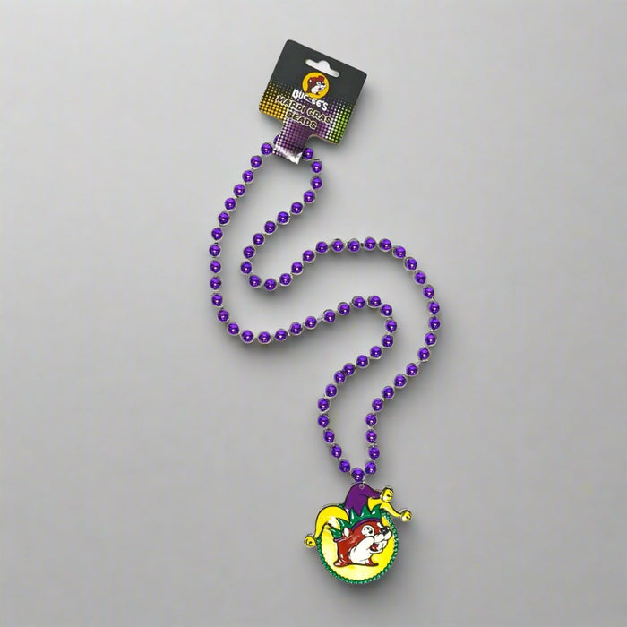 A necklace of purple beads with a Mardi Gras themed pendant featuring a jester character.