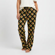 A pair of black pajama pants with a pattern of cartoon raccoon faces in a repeated design.